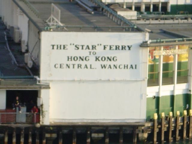 Sign reading The Star Ferry to Hong Kong Central Wanchai on the pier building