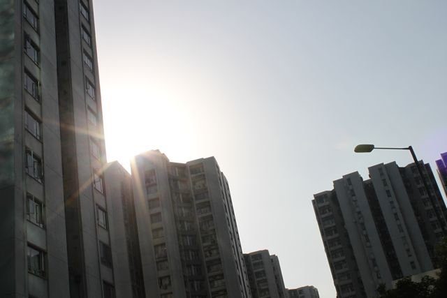 Sun flare between Hong Kong residential tower blocks