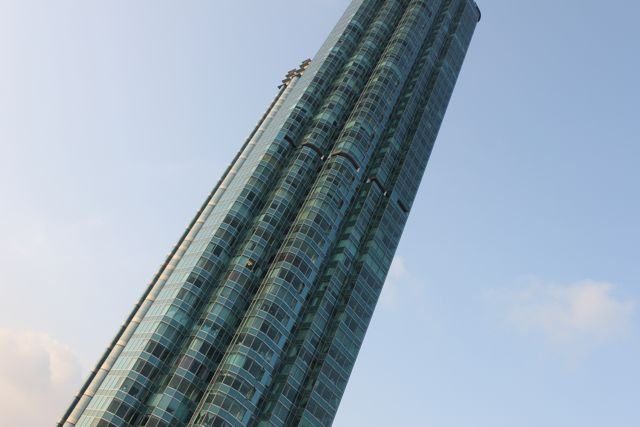 Glass-fronted skyscraper shot from below against the sky