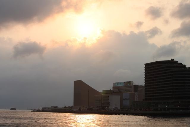 Hong Kong Cultural Centre and waterfront buildings silhouetted at sunset