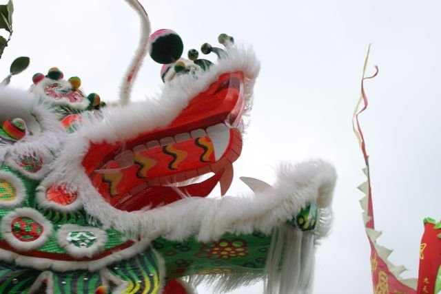 Close-up of a colourful lion dance head in red, green and white