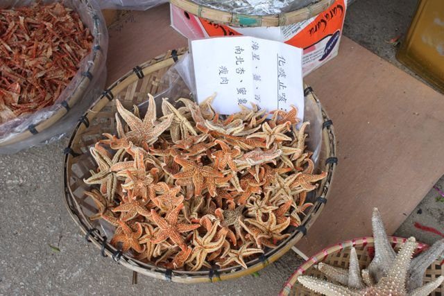 Dried starfish for sale in baskets at a market stall