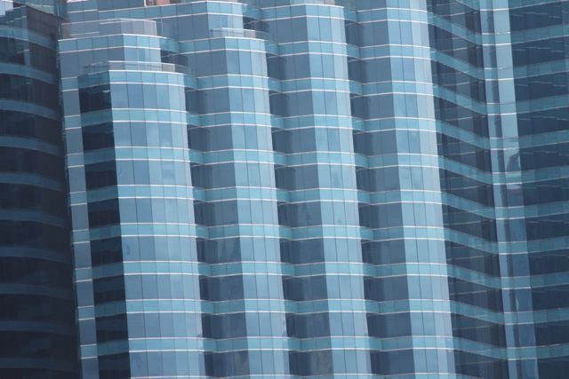 Close-up of curved blue glass skyscraper facades