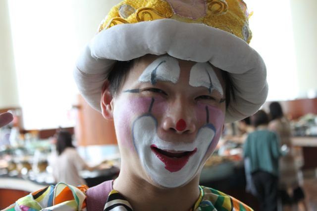 Clown entertainer in face paint at a Hong Kong hotel buffet