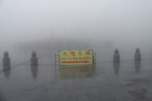 Go To Big Buddha direction sign in thick fog on Lantau Island