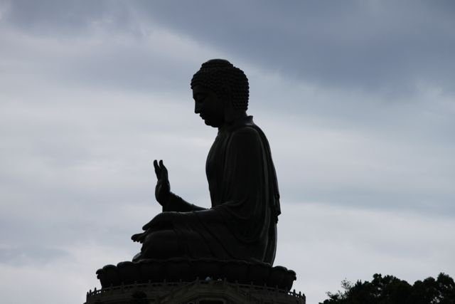 Big Buddha silhouetted against an overcast sky on Lantau Island