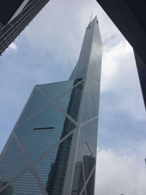 Bank of China Tower seen from street level, geometric facade soaring skyward