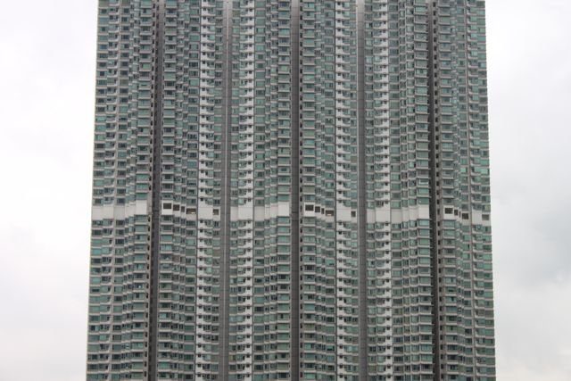 Dense residential tower block facade with hundreds of windows