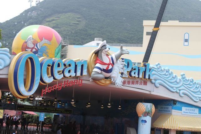 Ocean Park Hong Kong entrance with mascot and green hills behind