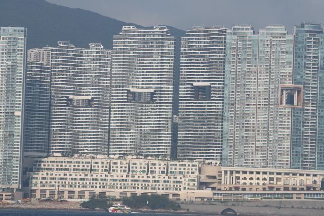 Wall of high-rise residential towers seen from the harbour