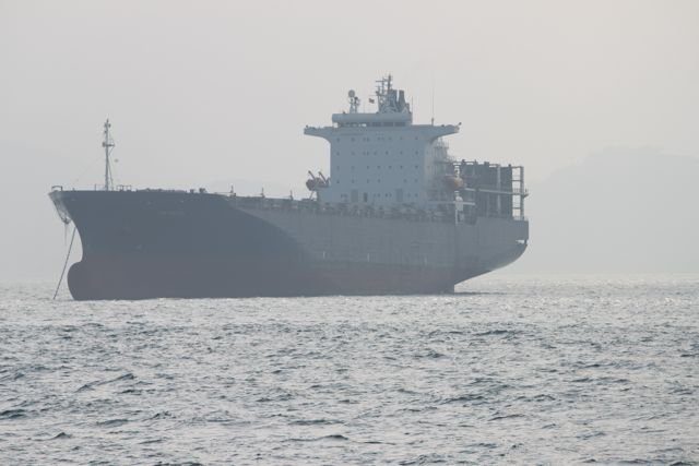 Cargo ship anchored in hazy waters off Hong Kong