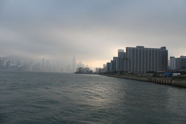 Hong Kong skyline disappearing into mist and low cloud from the harbour