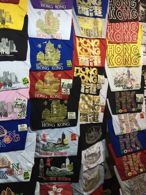 Wall of Hong Kong souvenir T-shirts stacked in every colour and design