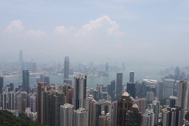 Central district skyline from Victoria Peak, harbour and Kowloon visible through haze